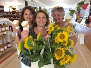 Some ladies with ice cream and flowers